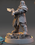 A detailed 3D model of a warrior figure, likely from a fantasy or science fiction game, standing on a rocky base and holding a weapon.