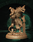 a statue of a demon holding a staff