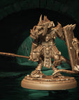 a statue of a demon holding a sword