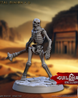 a skeleton figurine holding a stick in a desert setting