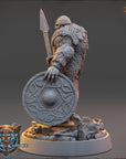 A detailed 3D model of a warrior figure holding a shield and spear, standing on a rocky base.