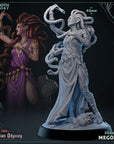 a statue of a woman holding a snake next to a statue of a woman