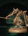 a statue of a demon holding a sword and shield
