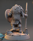 A detailed 3D model of a fantasy character, likely a dwarf or elf, standing on a rocky platform and holding a shield and a spear.