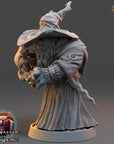 A 3D rendering of a wizard-like character from the video game "The Wardens of Fear". The character is wearing a long robe and a pointed hat, and is holding a staff. The character is standing on a base with the game's title and logo visible.