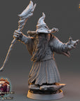 A 3D model of a wizard or magical figure, holding a staff and wearing a long robe, standing on a rock. The image is from the video game "The Warriors of Fear".