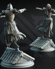 two statues of a person in a flowing robe, standing on a platform with a tiled roof.