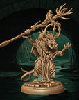 a statue of a demon holding a large stick