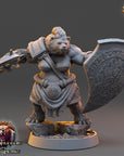 A 3D model of a female warrior figure, wearing a fur-trimmed outfit and wielding a shield with a symbol on it.