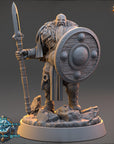 A detailed 3D model of a dwarf warrior standing on a rocky base, holding a shield and a spear.