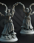 two detailed sculptures of a woman with multiple arms, each holding a gun. The sculptures are set against a dark background, emphasizing their intricate details and the contrast between the dark background and the sculptures.
