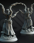 two statues of women with raised arms, each holding a gun.